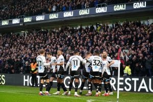 derby county celebrating at the corner flag after a goal.