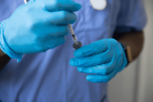 man holding an injection