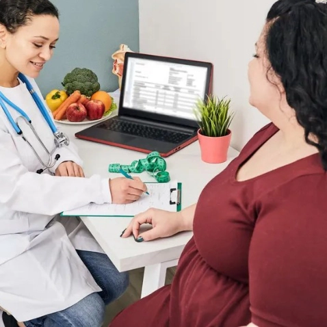 Photo of Woman Sat with Doctor