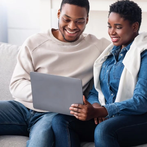 Photo of Couple Using Laptop