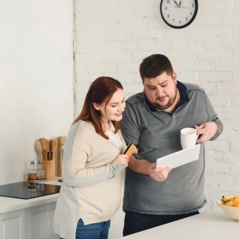 Photo of Couple Looking at Paperwork
