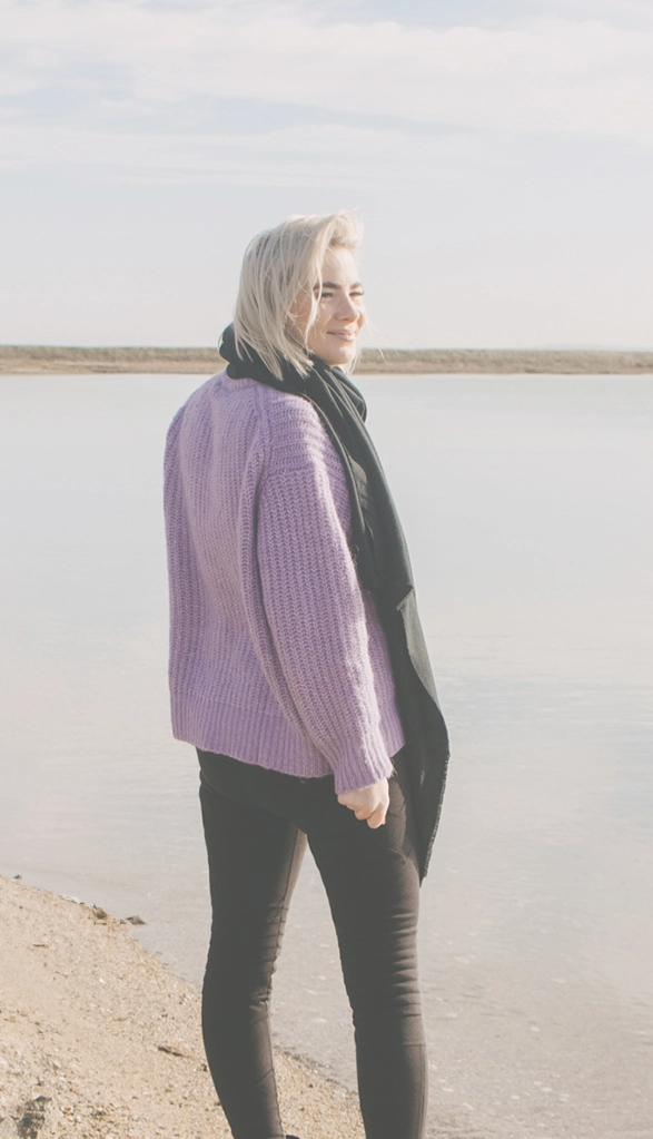 Photo of Woman in Pink Jumper on Beach