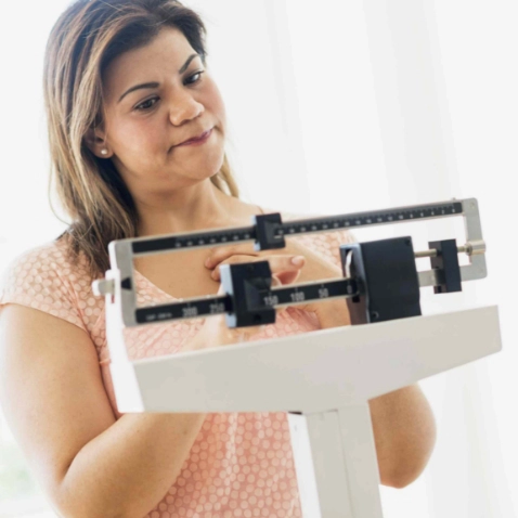 Photo of Woman Looking at Scales